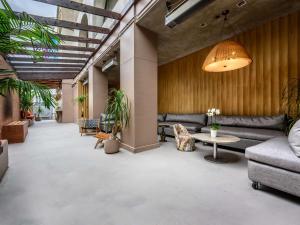 a living room with a couch and a table at Hotel Sofitel Los Angeles at Beverly Hills in Los Angeles