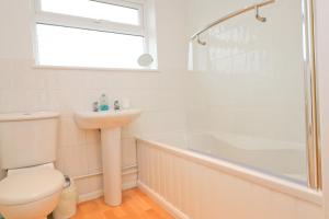 a bathroom with a toilet and a sink and a shower at 7 BAYS for 7 DAYS! Spacious bungalow near 7 beaches in St Merryn