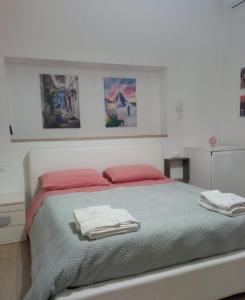 a bedroom with a bed with two towels on it at Suite Europa in San Vito dei Normanni