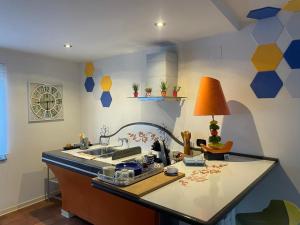 a kitchen with a sink and a table with a lamp at Capri Sky Loft in Boscoreale