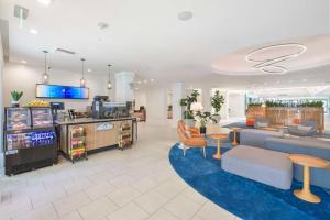 a lobby of a store with a couch and chairs at Hilton Irvine/Orange County Airport in Irvine