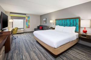 a hotel room with a bed and a flat screen tv at Hampton Inn Daytona/Ormond Beach in Ormond Beach