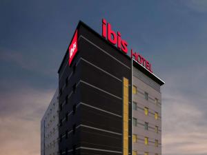 a building with a sign on top of it at ibis Kochi City Centre - An Accor Brand in Cochin