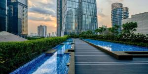 a pathway in the middle of a city with tall buildings at Alila SCBD Jakarta in Jakarta