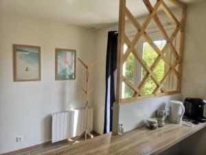 a window in a room with a wooden counter at La Bohème - Maison + Parking (Portes de Chartres) in Jouy