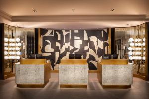 a lobby of a store with counters and a wall of wine bottles at Hilton Heidelberg in Heidelberg