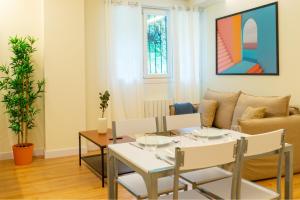 a living room with a table and a couch at BILBAO NORTH SHORE APARTMENTS 6 in Bilbao