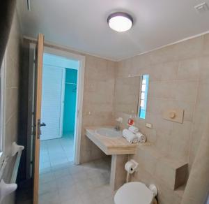 a bathroom with a sink and a toilet at Beachfront Acqua Villa in Five Islands Village