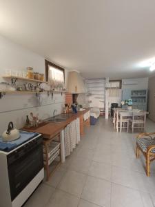 a kitchen with a sink and a stove top oven at Da Francesca in Palmadula +34 photos