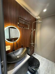 a bathroom with a black sink and a mirror at Kim Đồng homestay in Buôn Enao