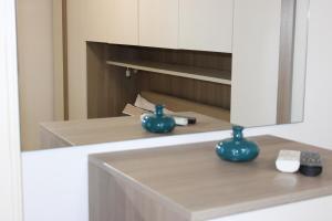 a bathroom with a sink with blue vases on it at Villa CasArte in Bari +22 photos