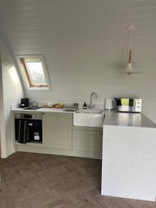 a kitchen with a sink and a counter top at The Pod @ Cold Comfort Farm in Hinckley