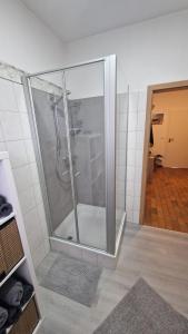 a shower with a glass door in a bathroom at Nordseebude in Husum