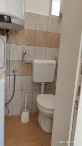 a bathroom with a toilet and a sink at Vazsita ház in Erdőbénye