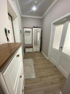 a kitchen with white cabinets and a door at Однокомнатные бизнес апартаменты в ЖК Заман in Atyraū