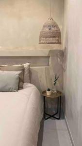 a bedroom with a bed and a nightstand with a table at Emuna House A Coruña in A Coruña