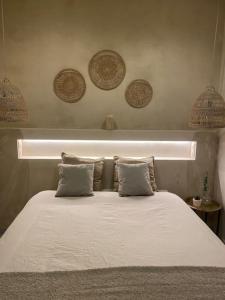 a bedroom with a bed with a light above it at Emuna House A Coruña in A Coruña