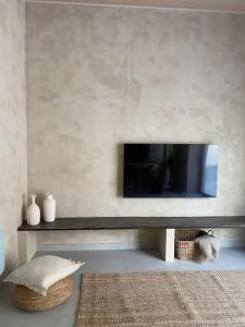 a living room with a flat screen tv on a wall at Emuna House A Coruña in A Coruña