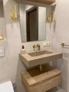 a bathroom with a sink and a mirror at Emuna House A Coruña in A Coruña
