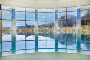 a swimming pool with a reflection in the water at ANA Crowne Plaza Resort Appi Kogen, an IHG Hotel in Hachimantai