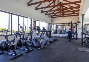 a woman standing in a gym with a bunch of bikes at Hotel Olivewood in East London