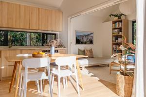 a kitchen and dining room with a table and chairs at Urban oasis with sauna in Wellington