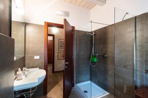 a bathroom with a sink and a shower at Al Battistero Luxury Suite in Ravenna