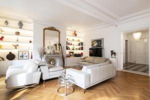 a living room with white furniture and a mirror at Deluxe Paris St Germain Suite in Paris