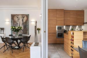 a kitchen and dining room with an elephant painting on the wall at Deluxe Paris St Germain Suite in Paris