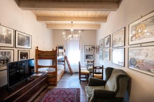 a living room with a tv and a couch at Al Battistero Luxury Suite in Ravenna