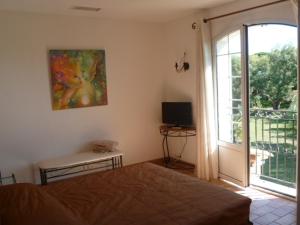 a bedroom with a bed and a sliding glass door at Chambre d'hôtes "La Bastide des Eucalyptus" in Antibes