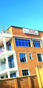 a brick building with a sign on top of it at Kivu Summer Hotel in Rubavu