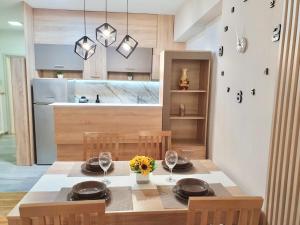 una sala da pranzo con tavolo e sedie e una cucina di Lux Apartment Dolce Casa Skopje Karpos IV a Dolno Nerezi