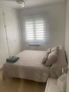 a bed in a white room with a window at Villa Jacaranda in Torre-Pacheco +18 photos