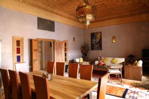 - un salon avec une table et des chaises en bois dans l'établissement Villa BEN - 3chambres, à Marrakech