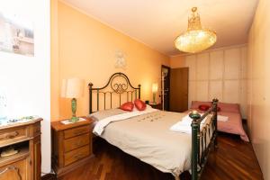 a bedroom with a bed with red pillows on it at Rachele’s charming house in the heart of Rome in Rome