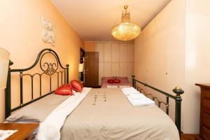 a bedroom with a large bed with red pillows at Rachele’s charming house in the heart of Rome in Rome
