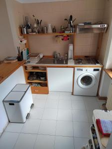 a kitchen with a sink and a washing machine at La MaisonB - Arly in La Thuile