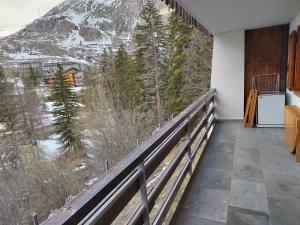 a balcony with a view of a snow covered mountain at La MaisonB - Arly in La Thuile