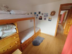 a bedroom with a bunk bed and a wooden floor at La MaisonB - Arly in La Thuile