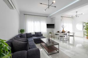 a living room with a blue couch and a table at Arcade Apartments in Volos