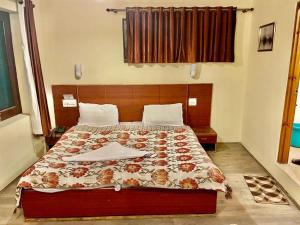 a bedroom with a large bed in a room at Hotel Town Centre , Srinagar in Srinagar