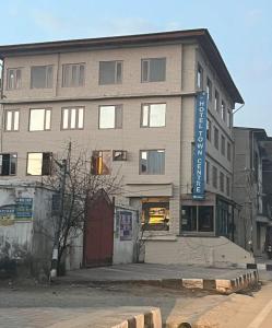 a building with a blue sign on the side of it at Hotel Town Centre , Srinagar in Srinagar