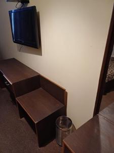 a room with two tables and a tv on the wall at Hotel Town Centre , Srinagar in Srinagar