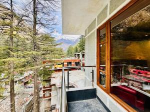 a balcony with a view of a mountain at The Kasol Parvati View by - ASIA HOLIDAYS in Kasol
