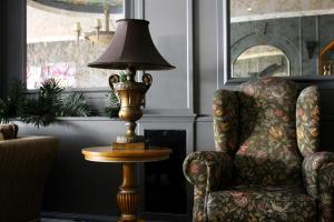 a lamp sitting on a table next to a chair at Funda Hotel in Trabzon