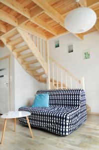 a living room with a checkered couch and stairs at RESET Mielno in Mielno