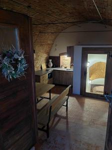 a kitchen with a table and a bench in a room at Sklipek Popice in Popice +5 photos