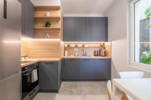a kitchen with gray cabinets and a window at Town Place - 1 Bedroom Apartment in Sofia