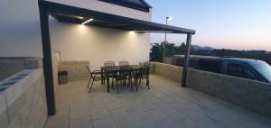 a patio with a table and chairs and a building at Sklipek Popice in Popice